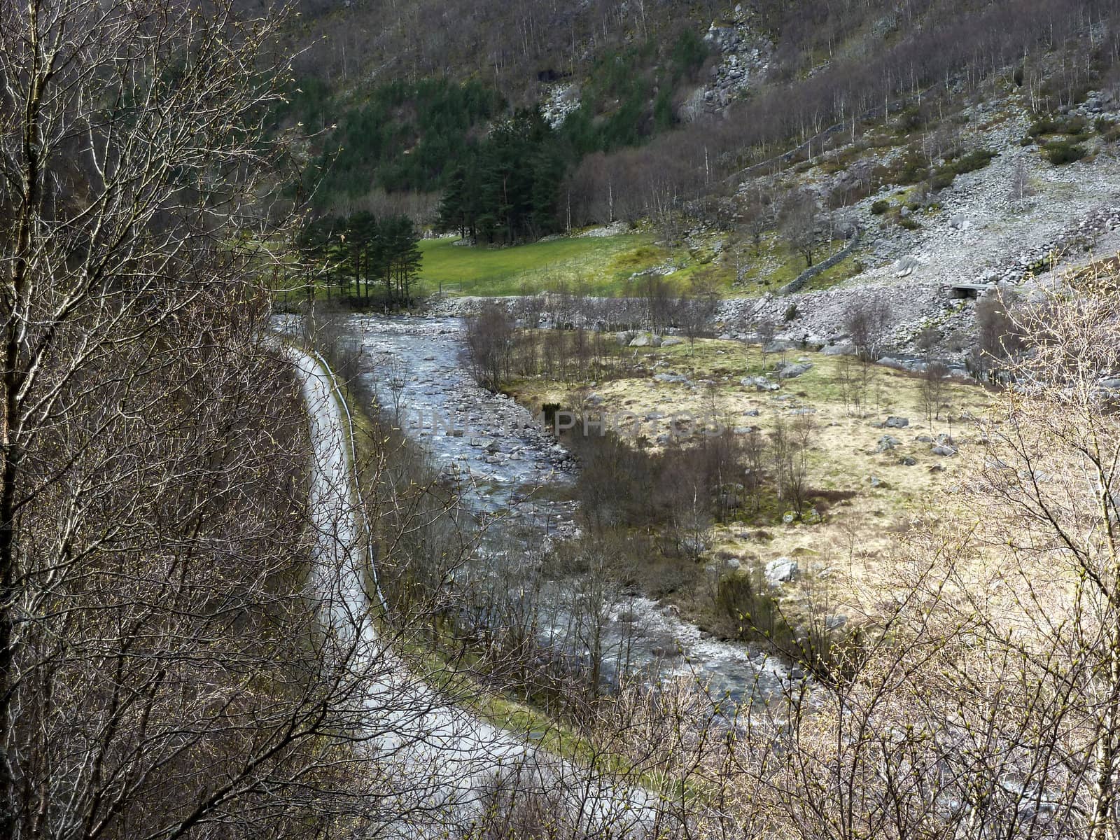 small river with road in rural landscape - norway, europe