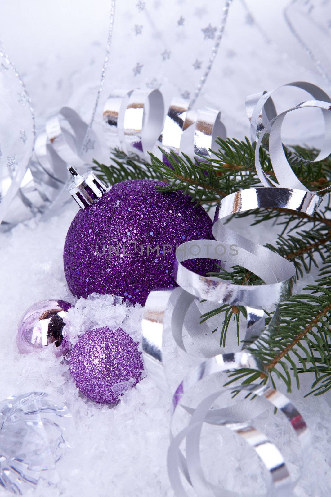 beautiful christmas decoration in purple and silver on white snow sparkle
