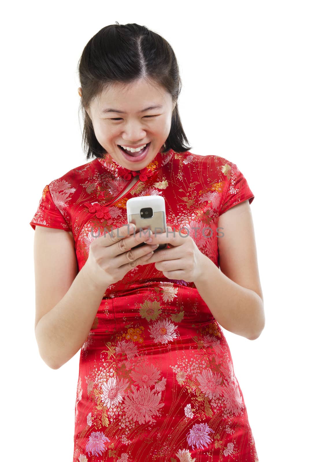 Happy oriental Asian woman using mobile phone to online / texting / sms , isolated on white background