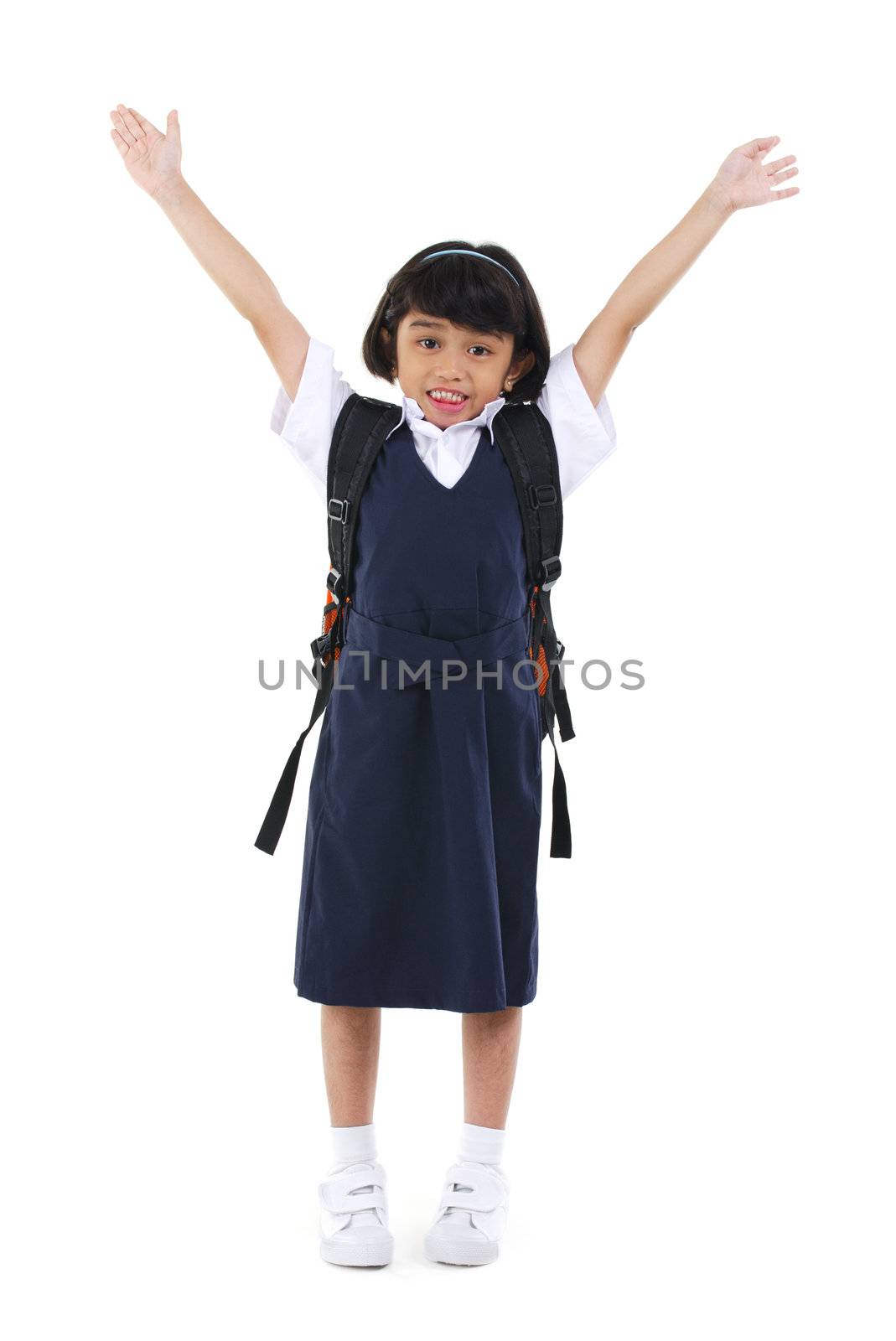 Six years old Southeast Asian school girl arms up in the air, fullbody over white background