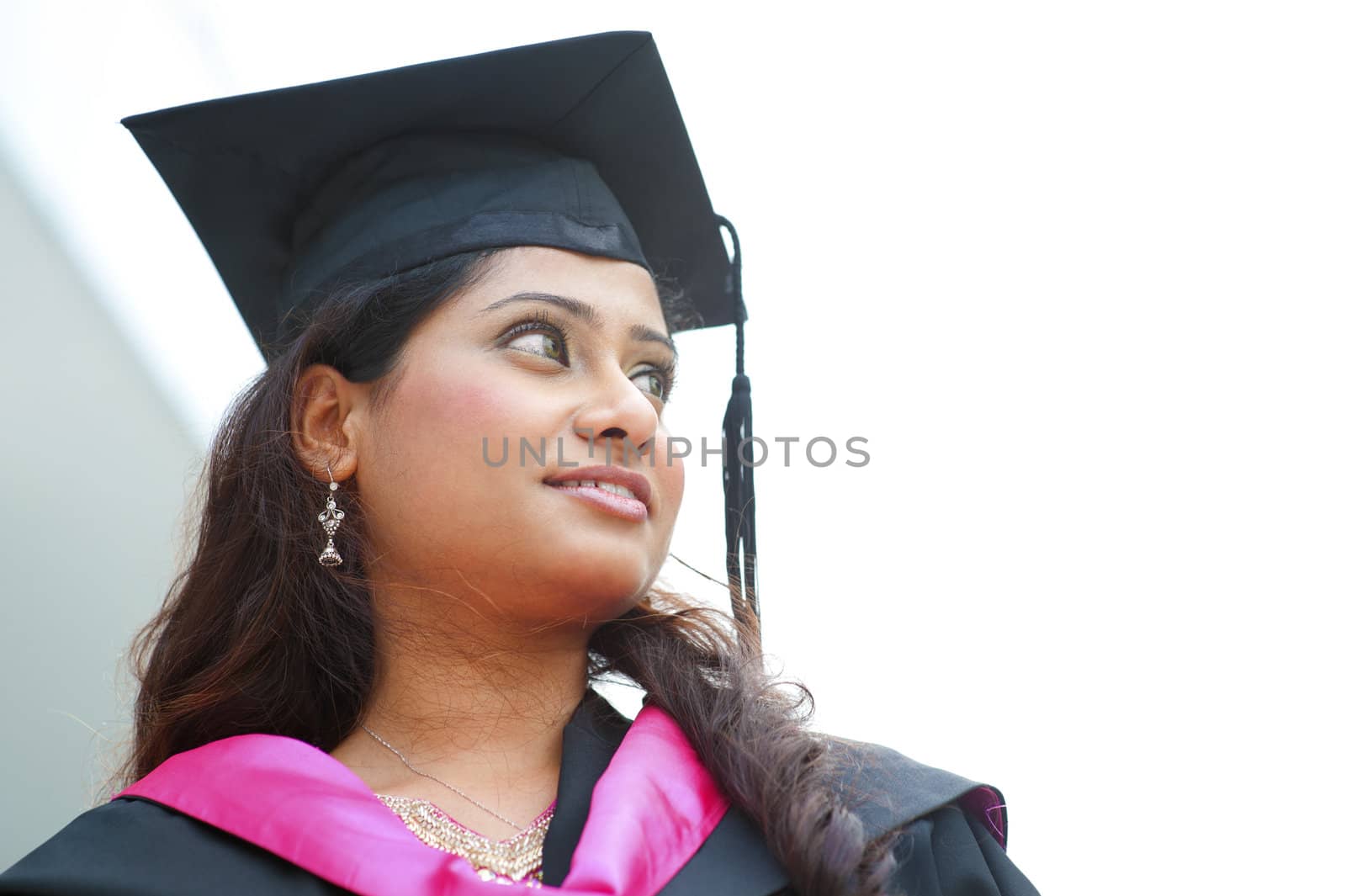 Young Asian Indian female student smiling and looking to bright side