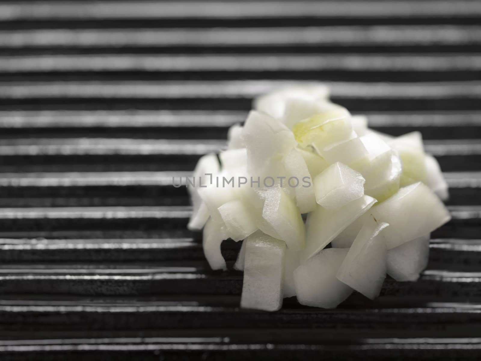 close up of chopped onions on a grill