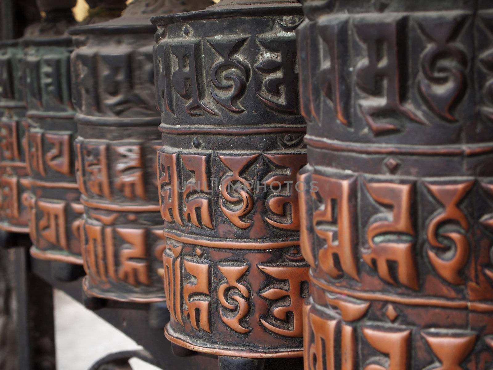 Decorated buddhist prayer wheels in a stupa.