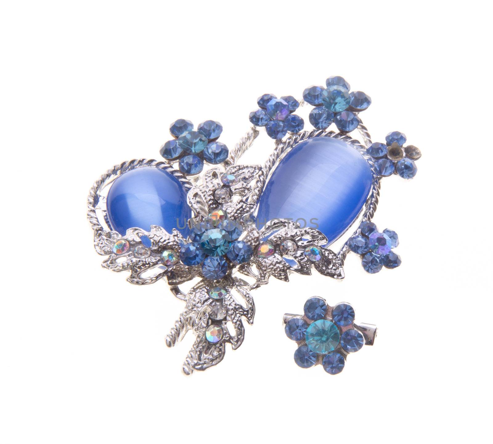 brooch with different gems on a background.