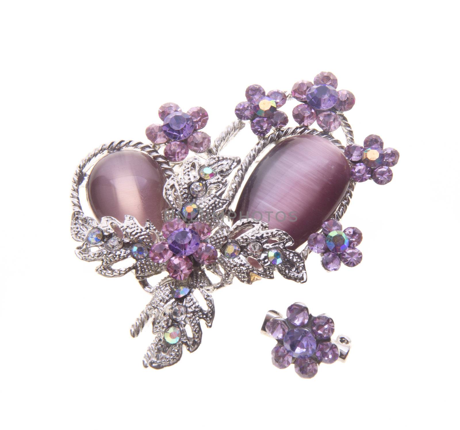 brooch with different gems on a background.