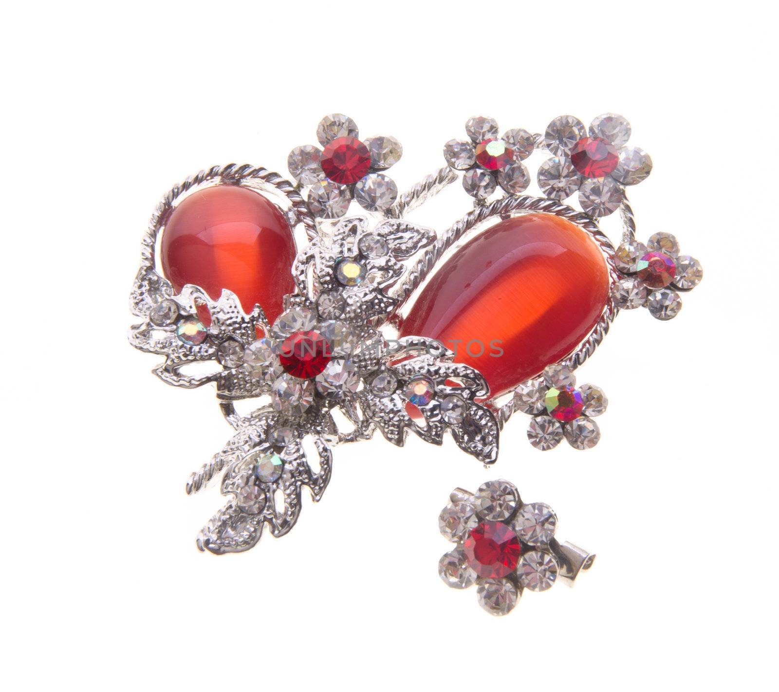 brooch with different gems on a background.
