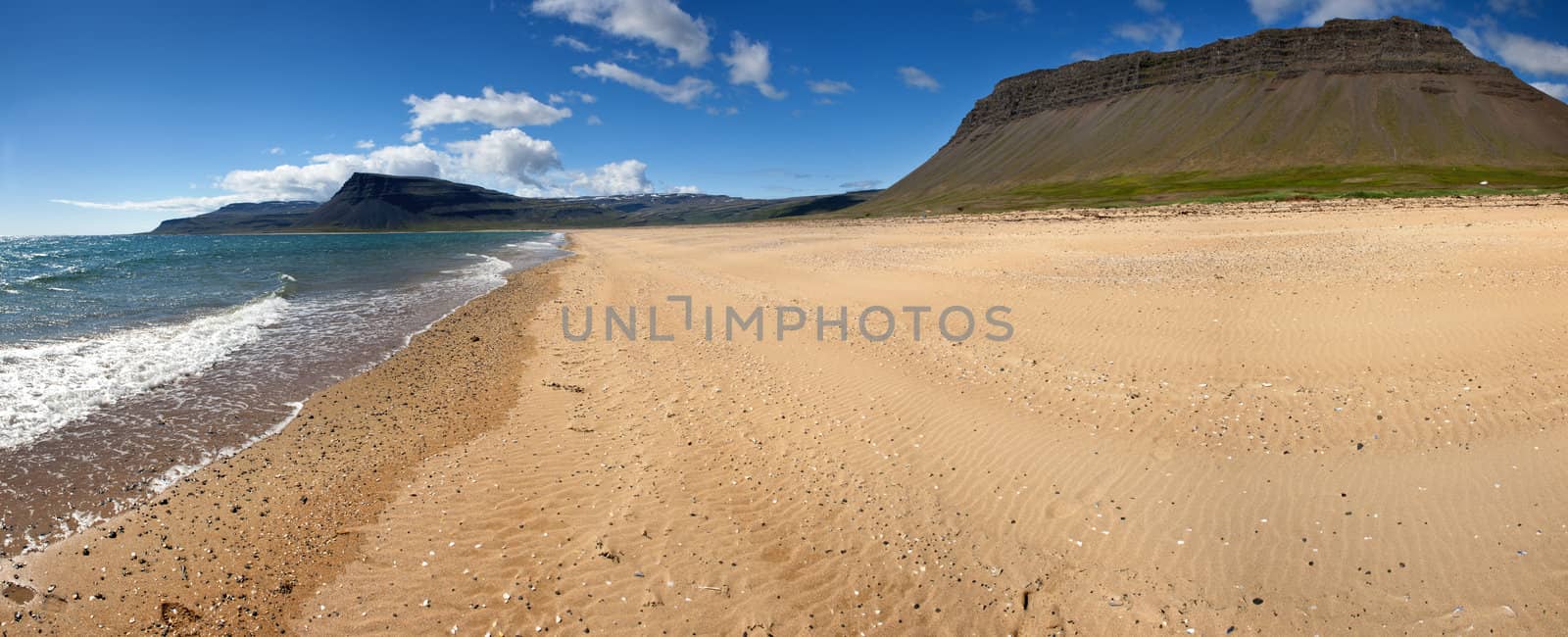 Beach under the mighty fjords rising from the sea in the Westfjords Peninsula, northwestern Iceland