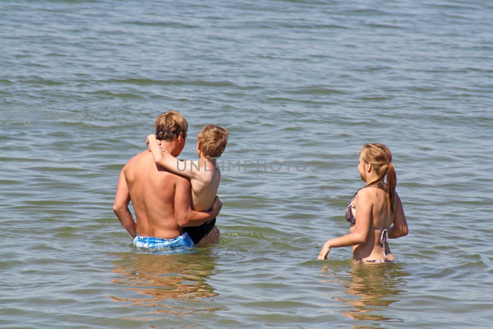 teenagers in the sea at cromer england