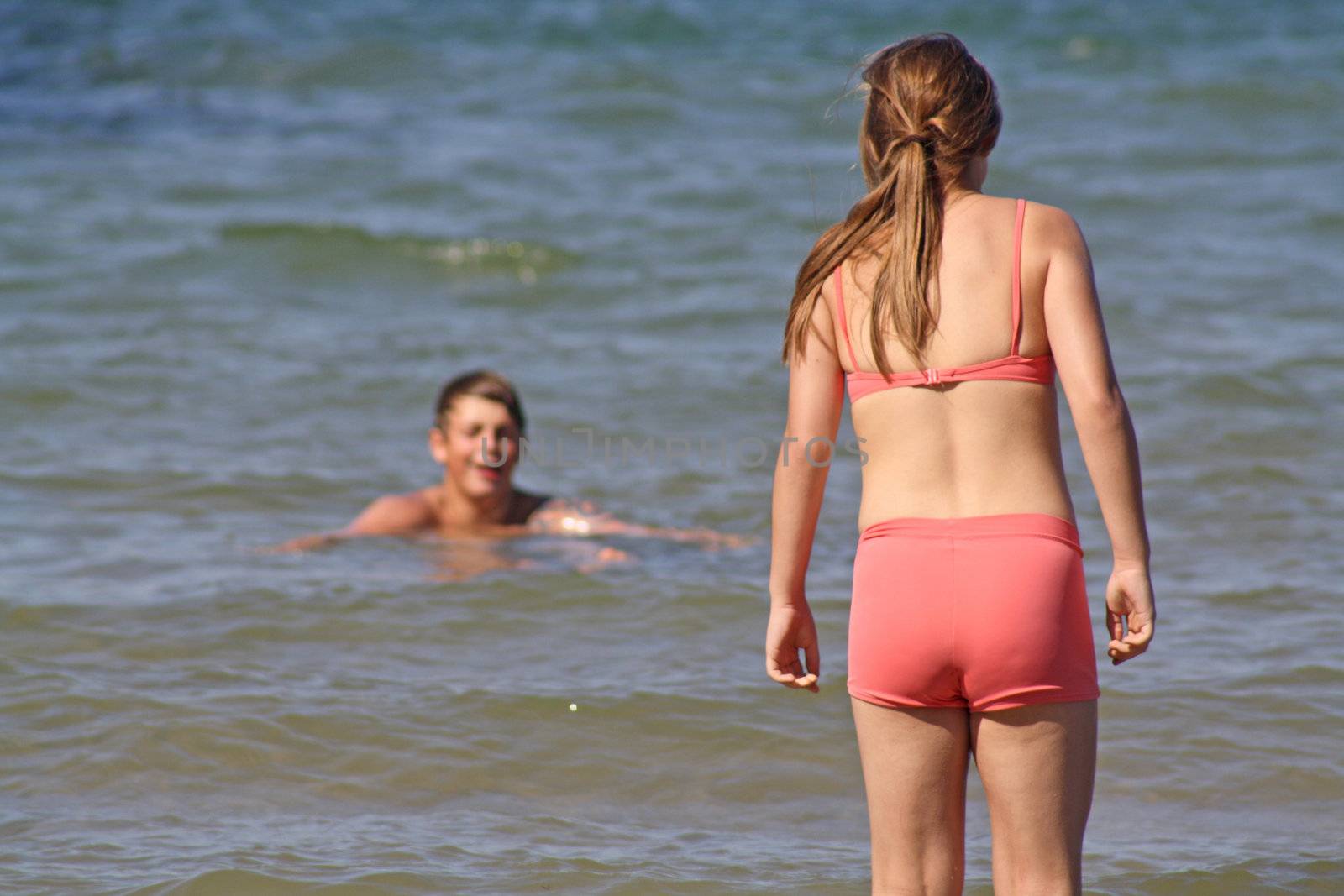 teenagers in the sea at cromer england