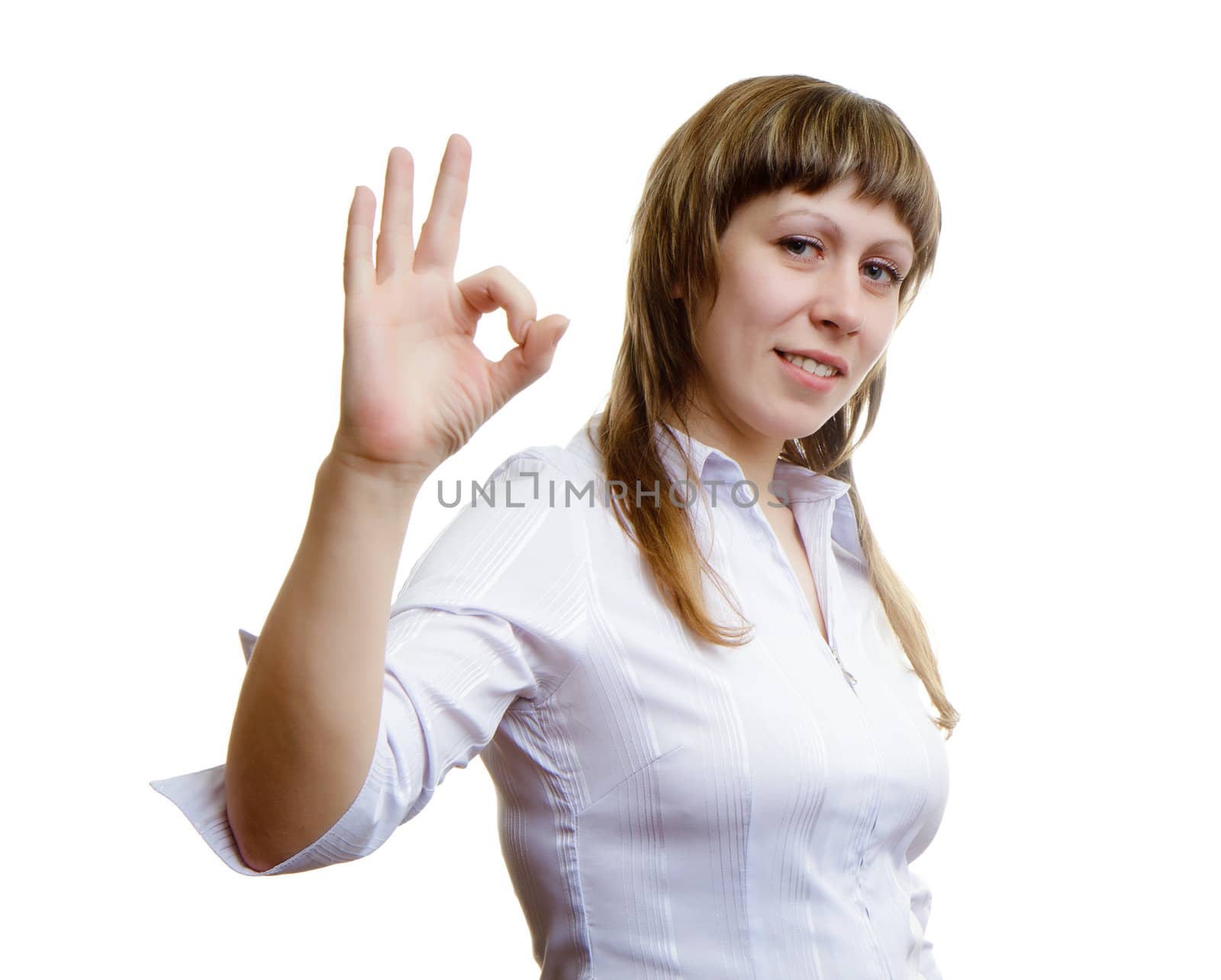 Young girl shows sign ok on a white background