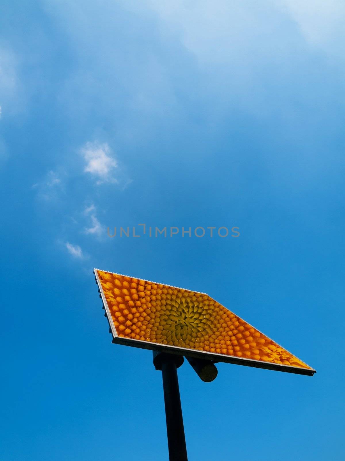 Solar panel under blue sky with clouds
