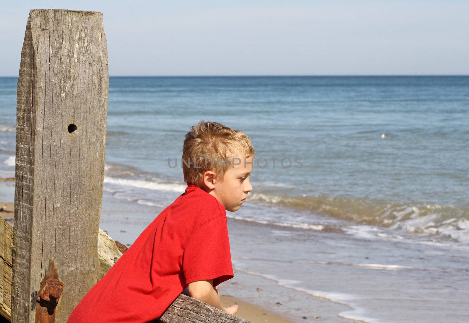 teenage boy looking out to sea