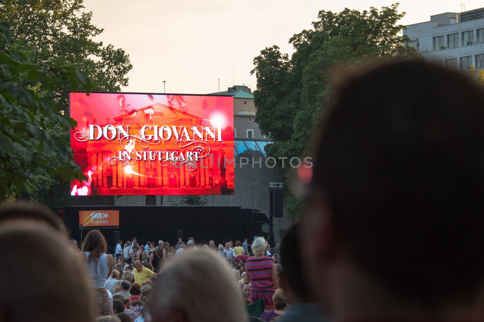 STUTTGART, GERMANY - JULY 25: More than 5.000 people are watching the public viewing of the premiere of Mozart´s opera “Don Giovanni” on a large screen in front of the Opera building in Stuttgart, Germany on July 25, 2012.
