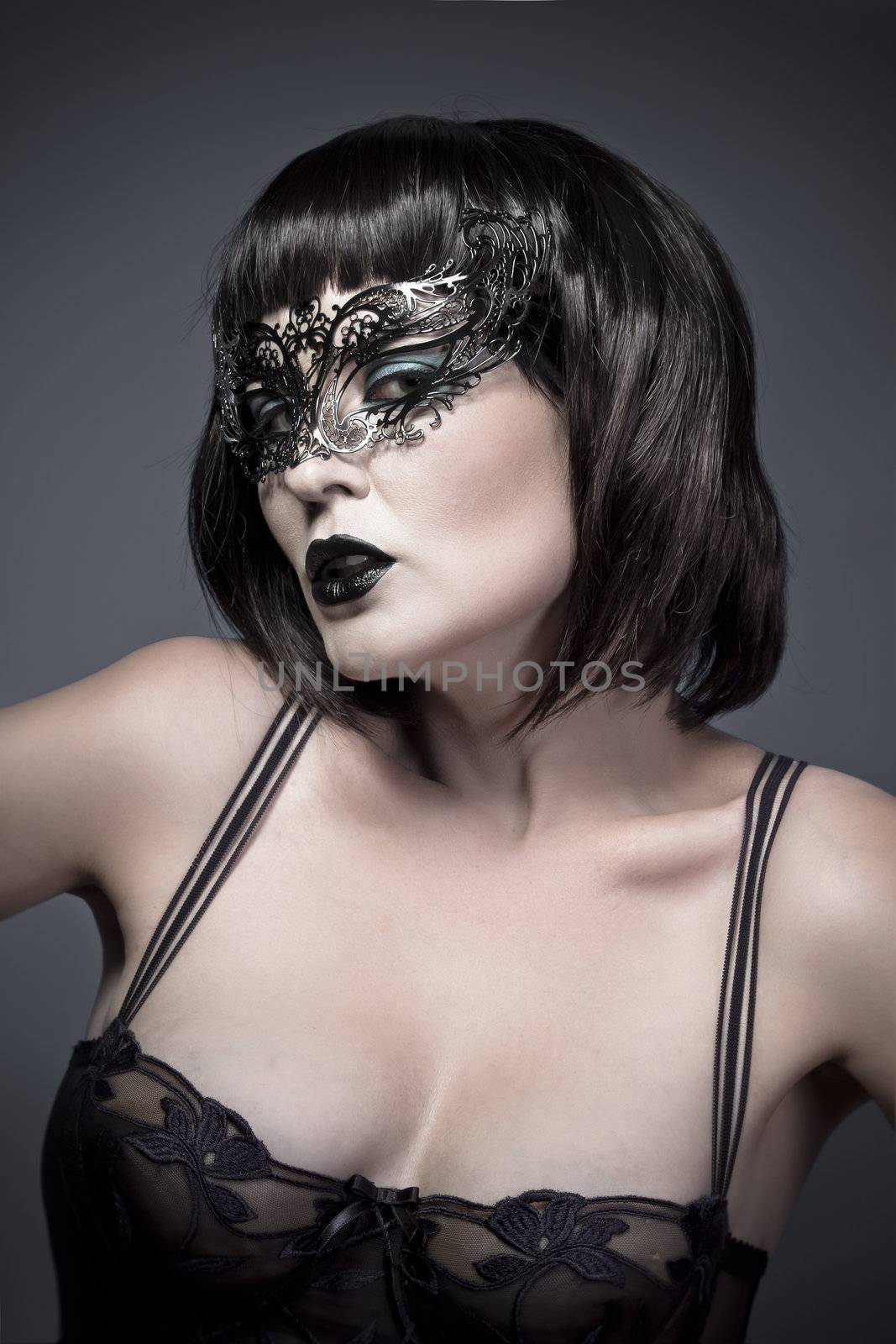 Sexy woman with black mysterious venetian mask and lingerie
