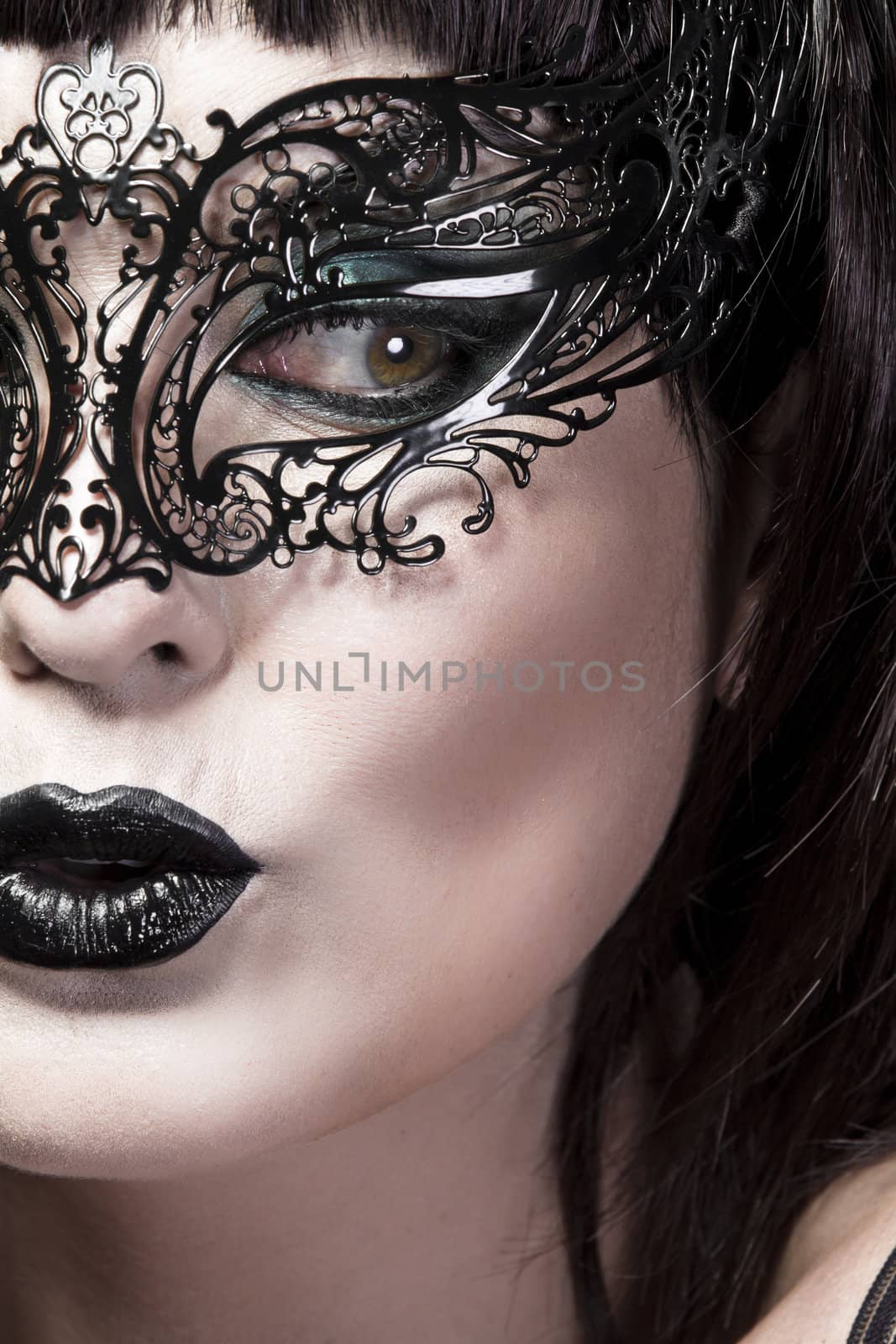 Detail of face of beautiful woman with delicate Venetian mask by FernandoCortes