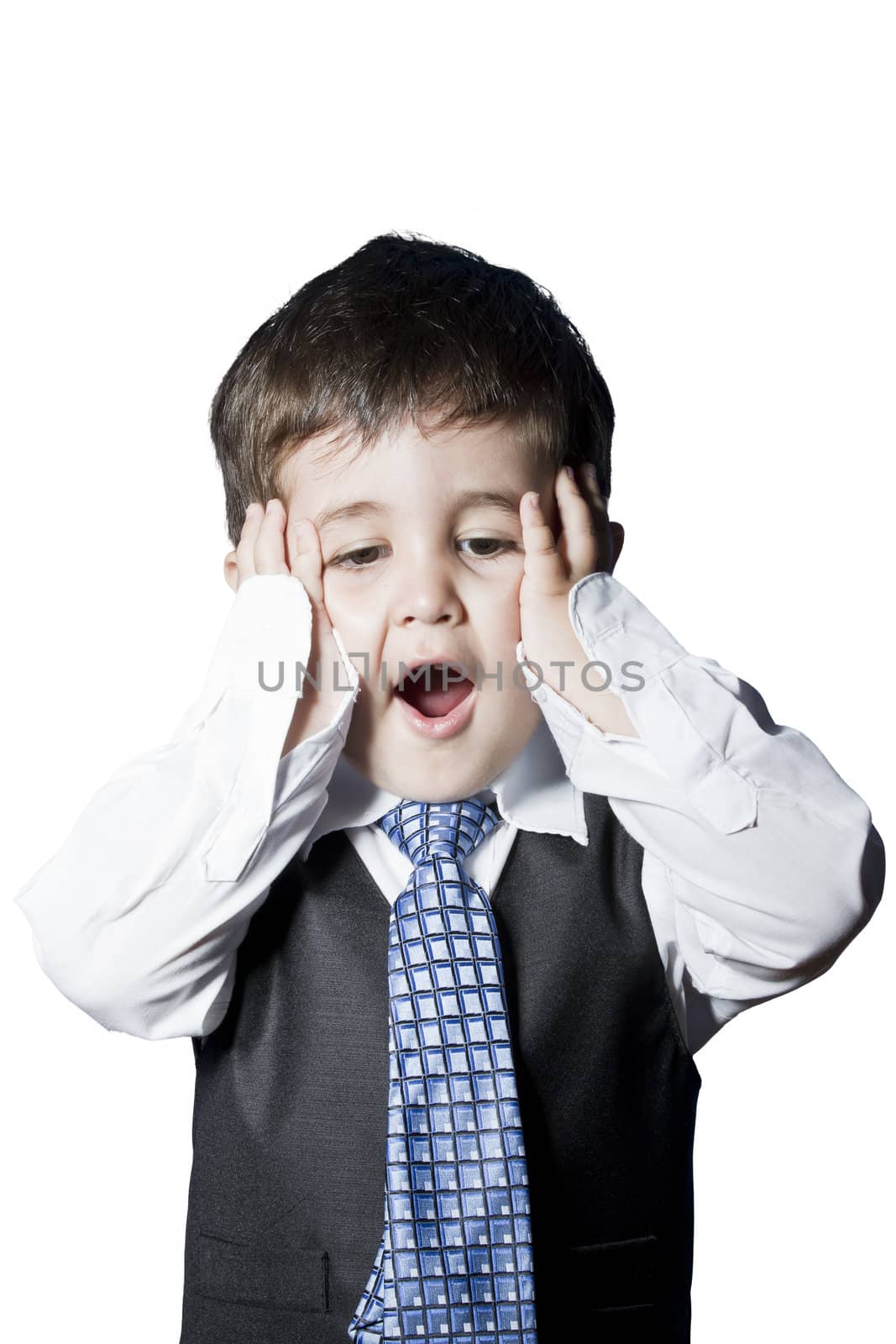 Child dressed like businessman with hands on his face surprised by FernandoCortes