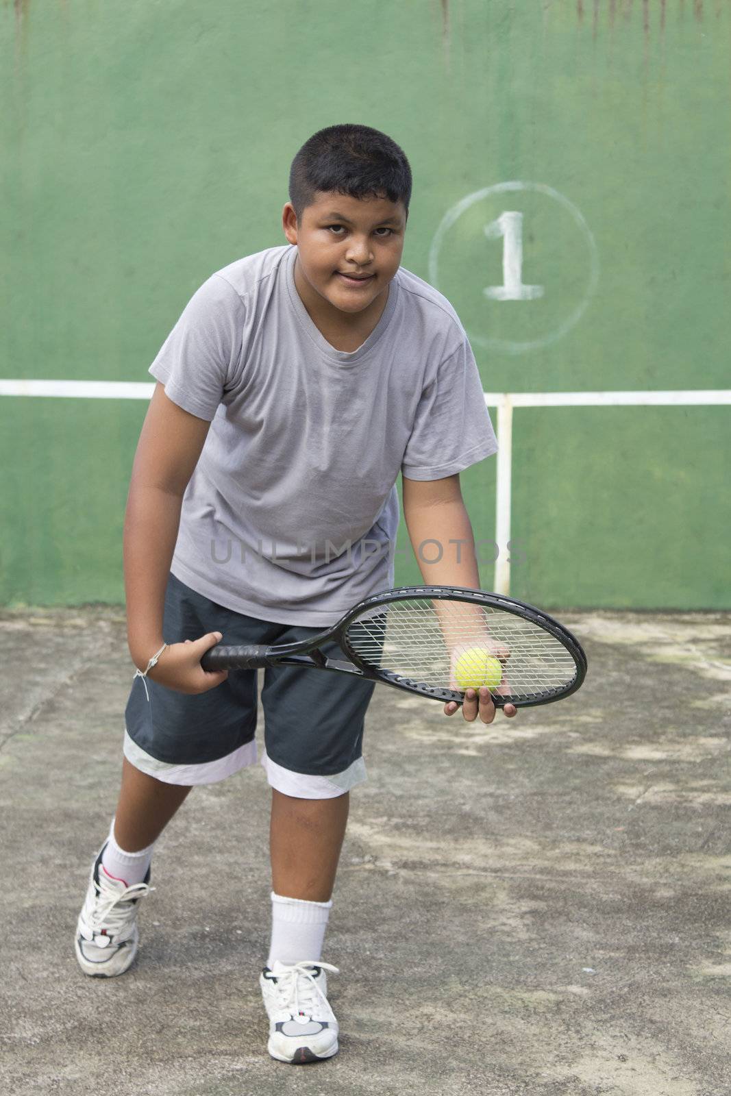 Boy tennis player getting ready to serve