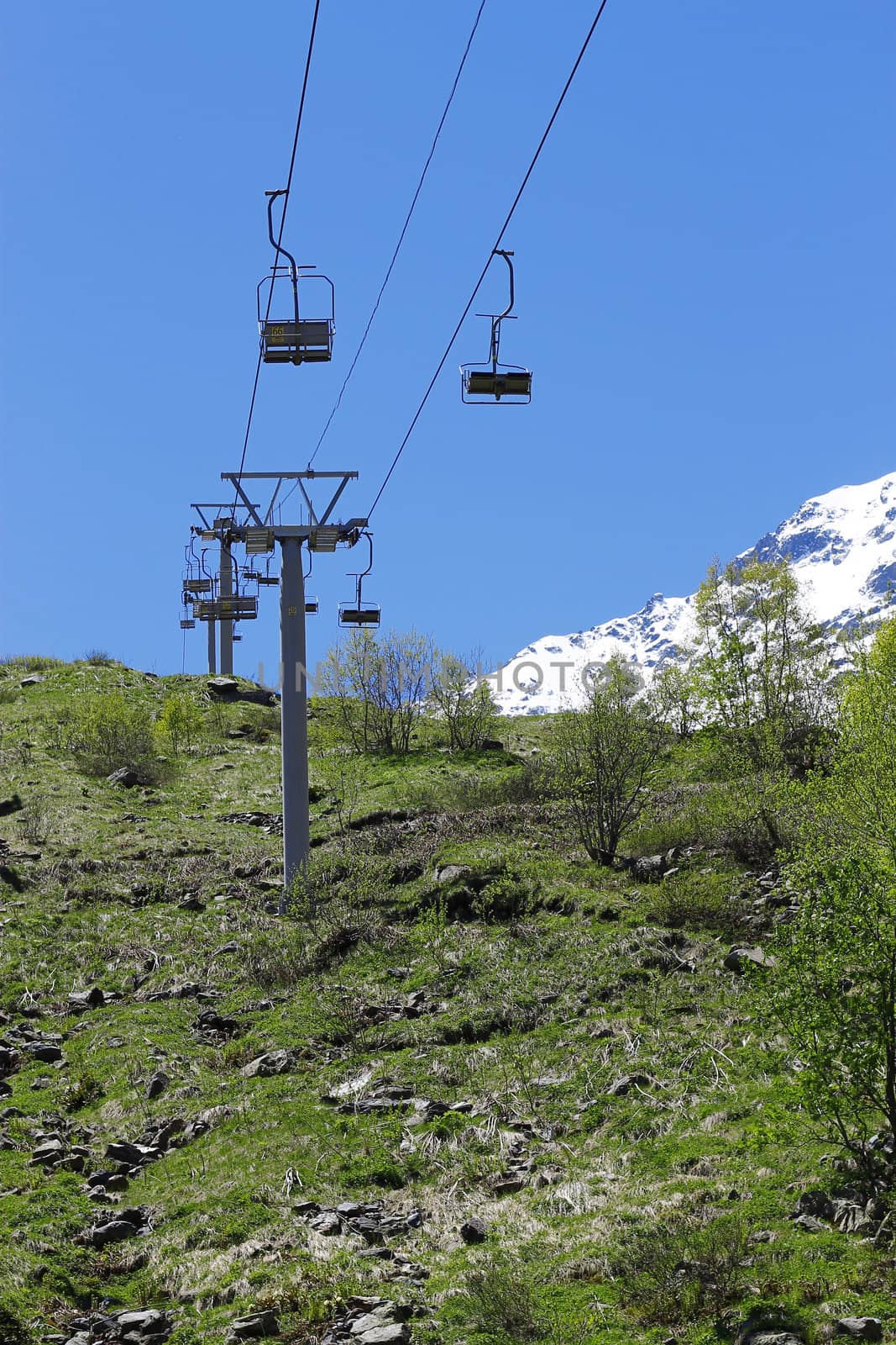 Empty cableway and caucasus mountains background