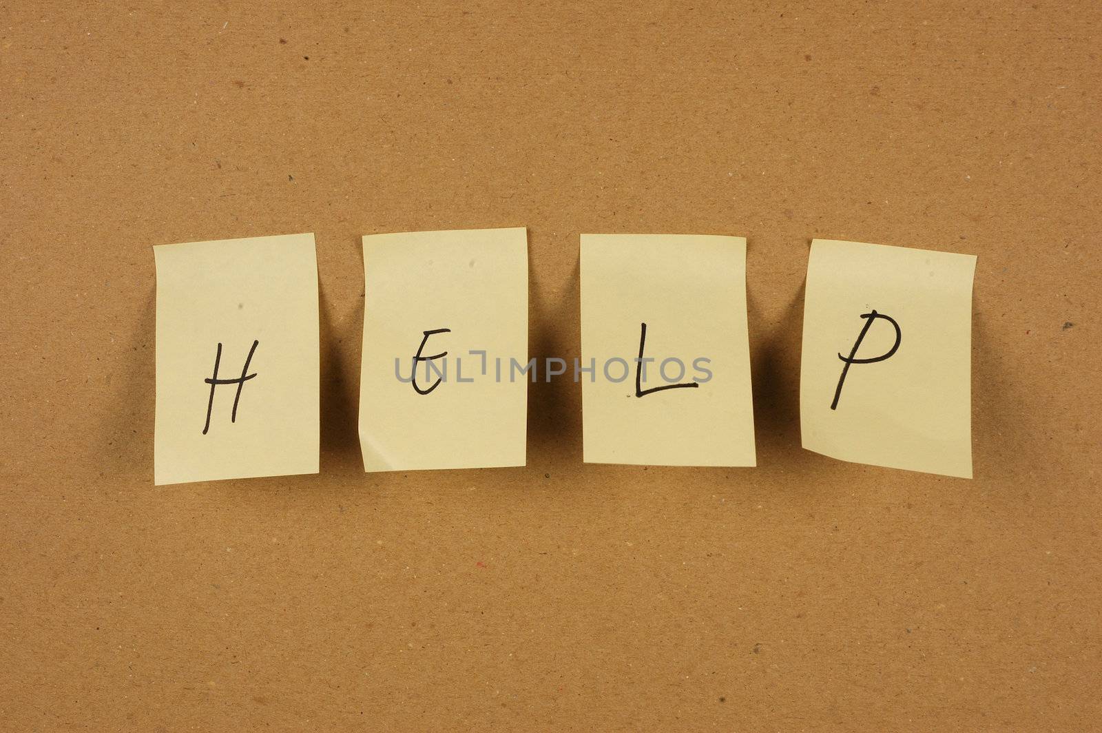 writing help is spelled in a sheet of paper affixed to the wall brown carton by antonihalim