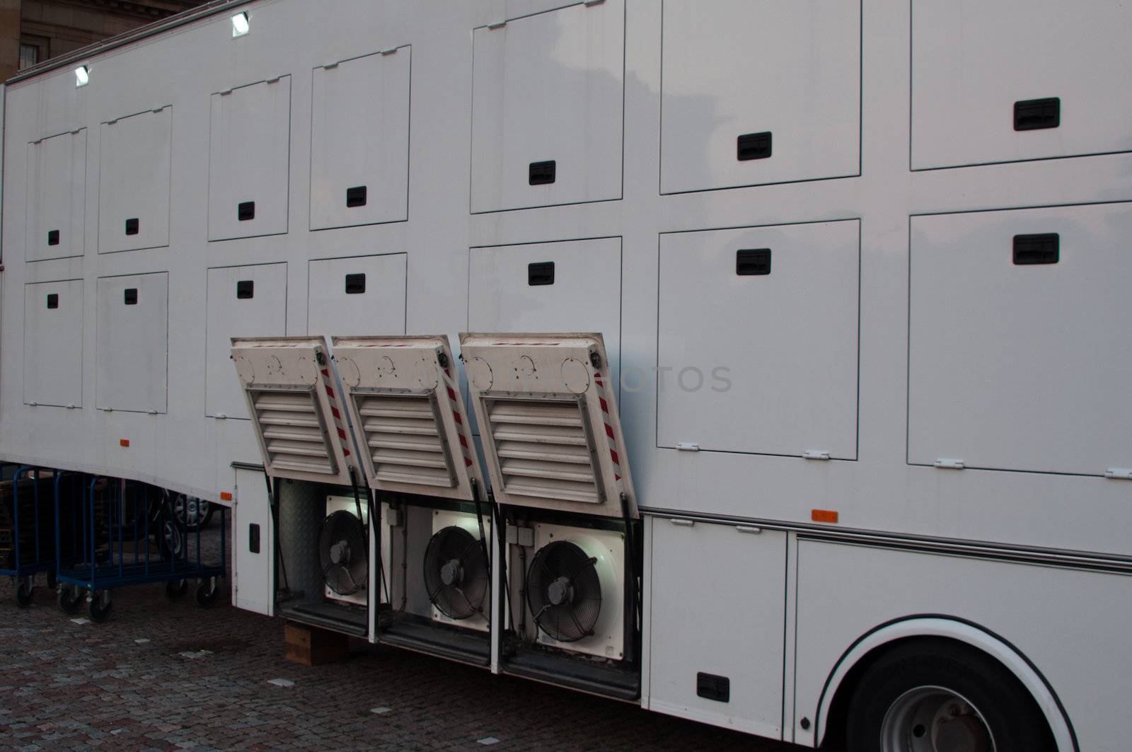 White broadcast truck recording and broadcasting a live event