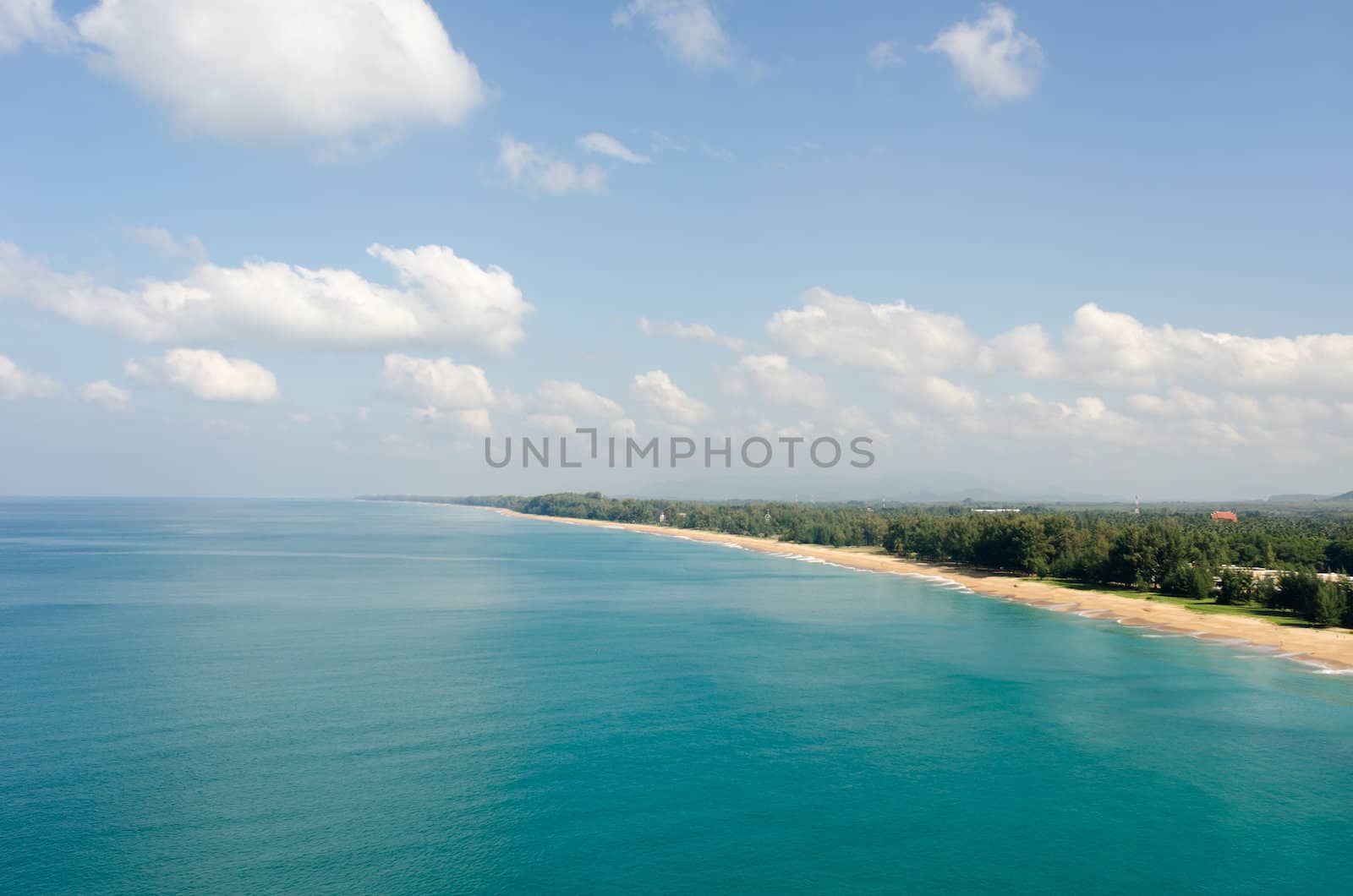 Aerial view of the tropical sandy sea coast with clear blue water