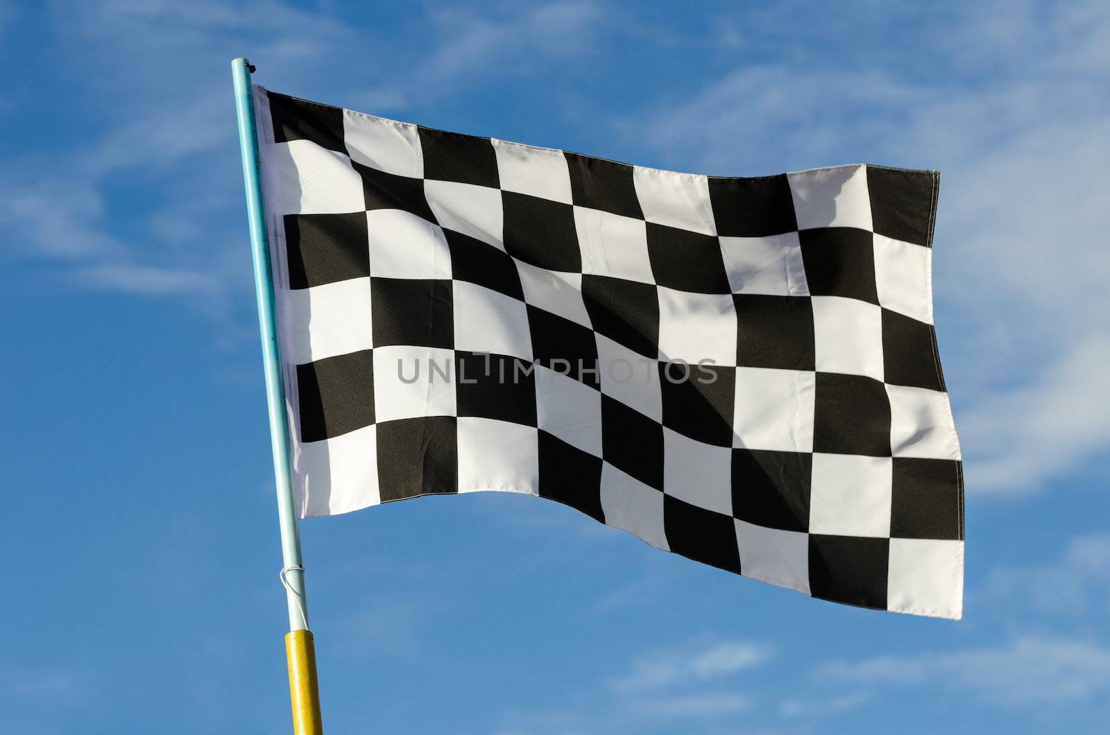 Checkered flag with blue sky on background