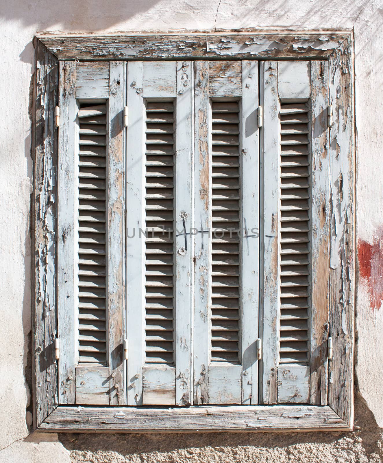 Aged and neglected wooden window in Athens, Greece.