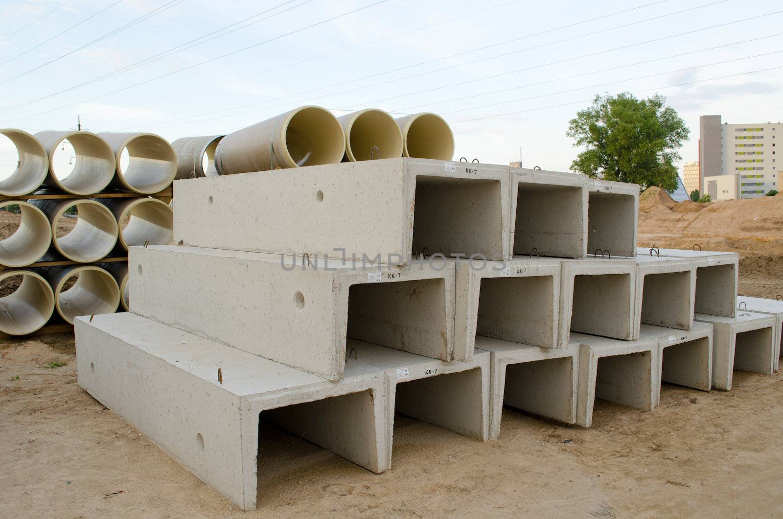 Materials used in road construction works. Concrete molds and plastic sewage pipes.