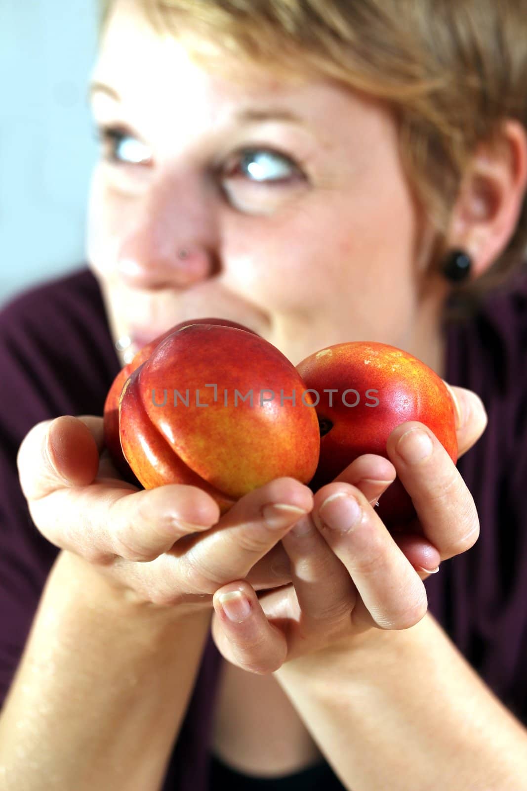 girl holding nectarines