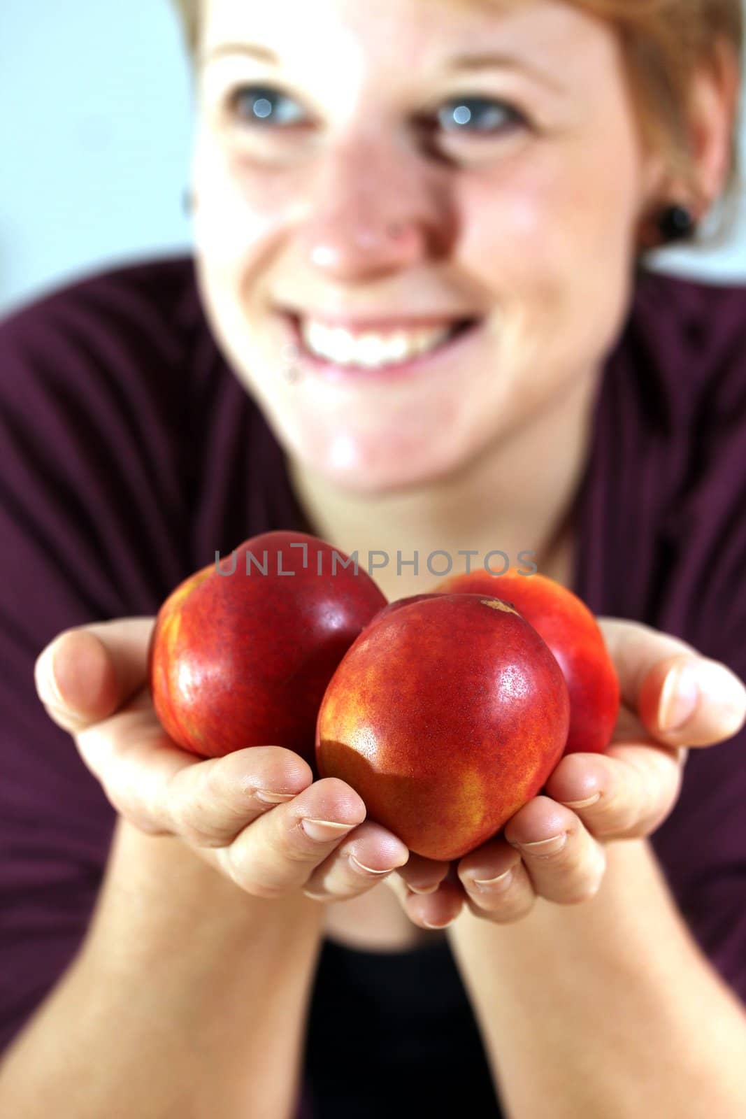 girl holding nectarines