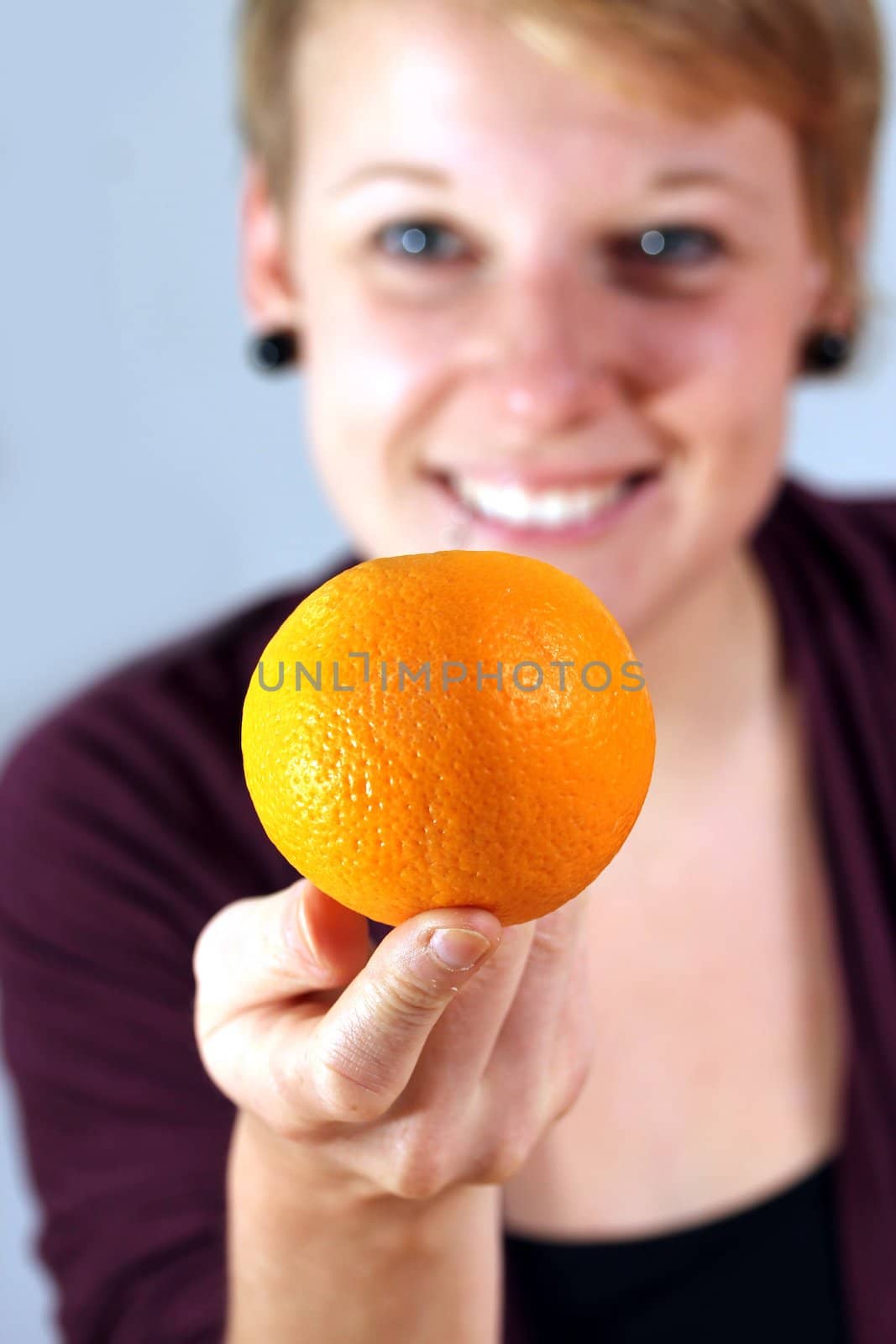 girl balancing an orange