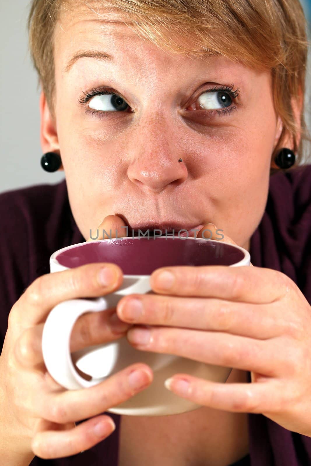 girl is drinking from a cup