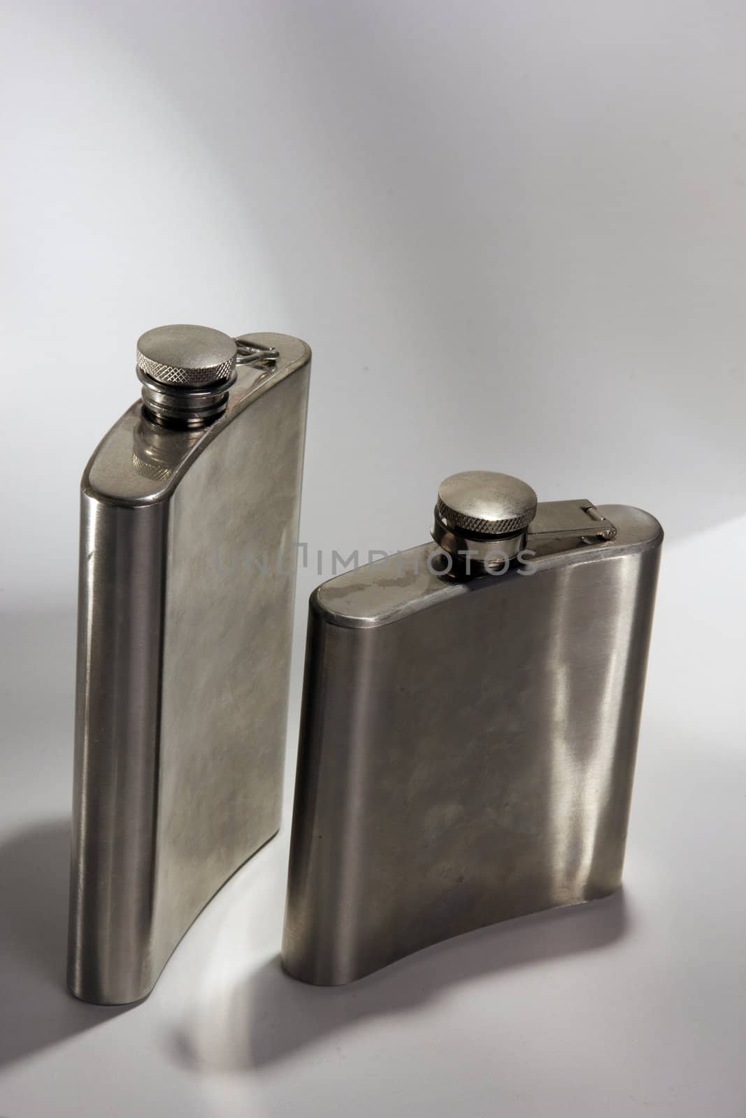 One of the most favorite men's toy - a metal flask for alcoholic beverages. Two used jars of stainless steel for whiskey or brandy