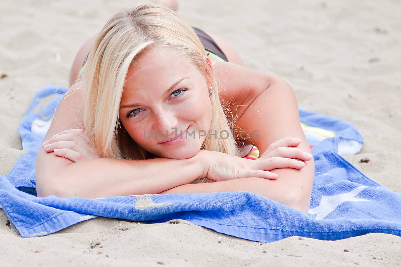 Photo of a young and beautiful woman resting on the sea coast