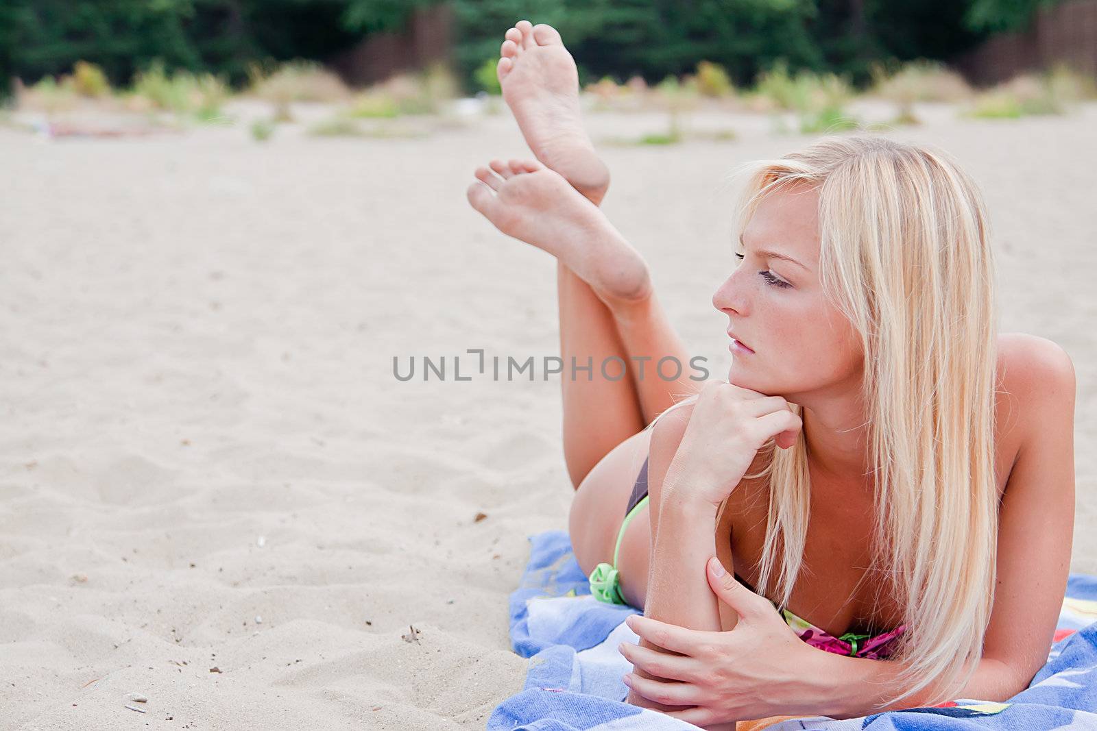 Photo of a young and beautiful woman resting on the sea coast