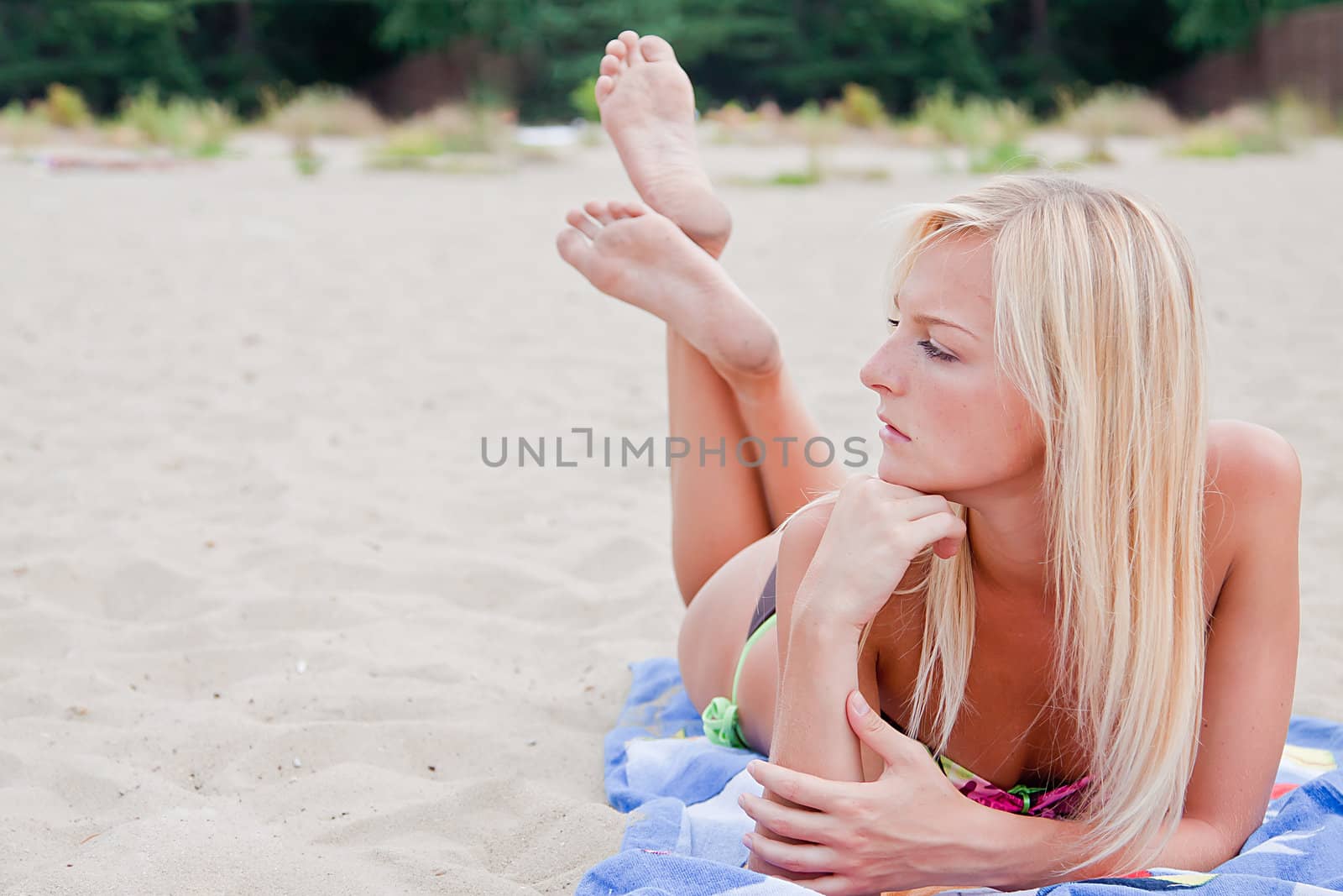 Photo of a young and beautiful woman resting on the sea coast