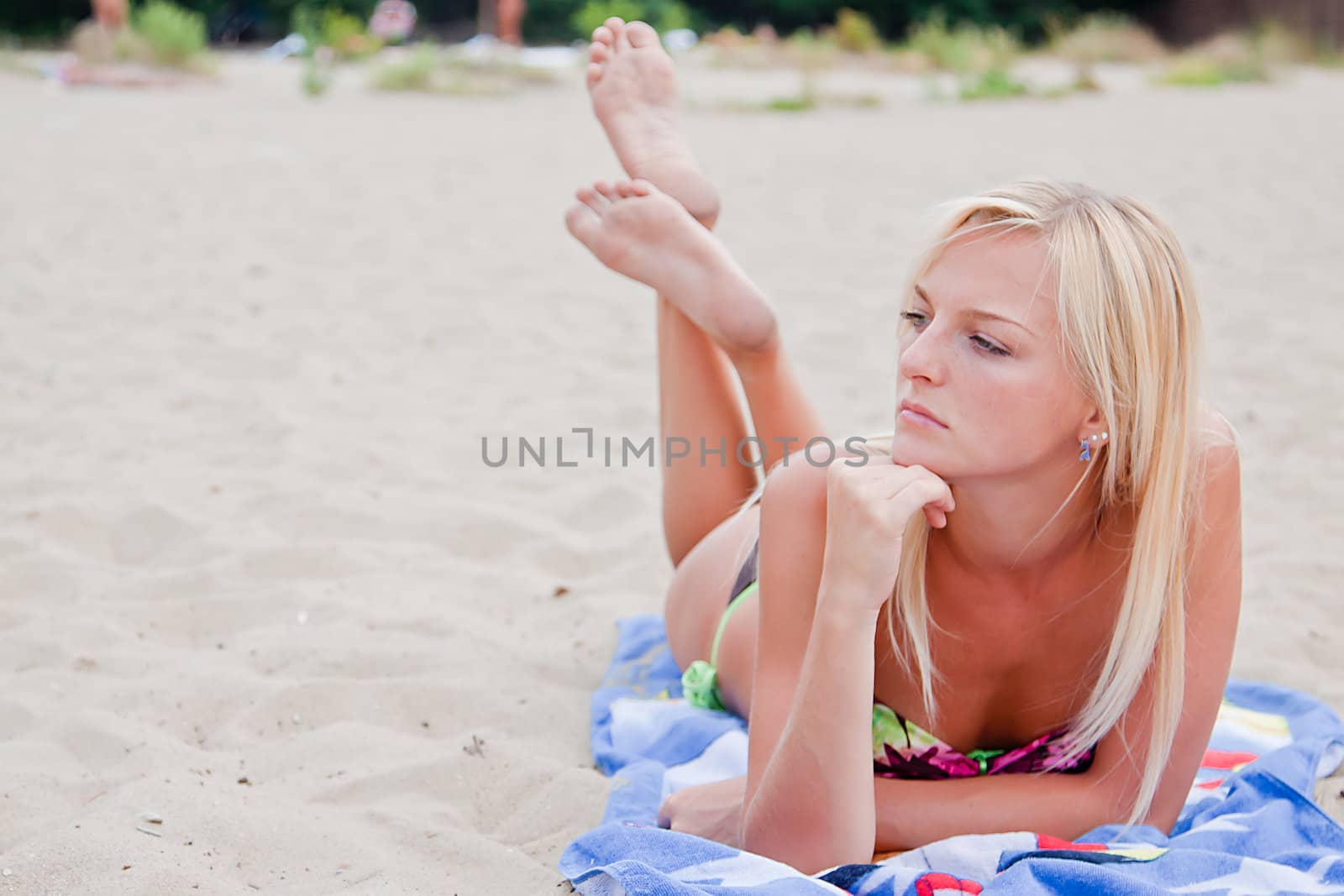 Photo of a young and beautiful woman resting on the sea coast