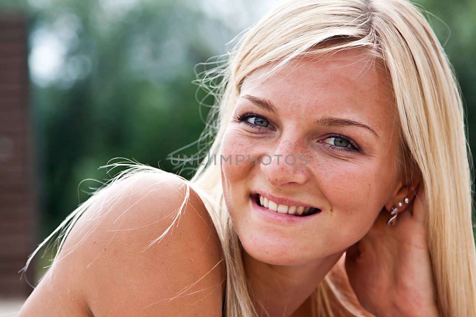 Photo of a young and beautiful woman resting on the sea coast