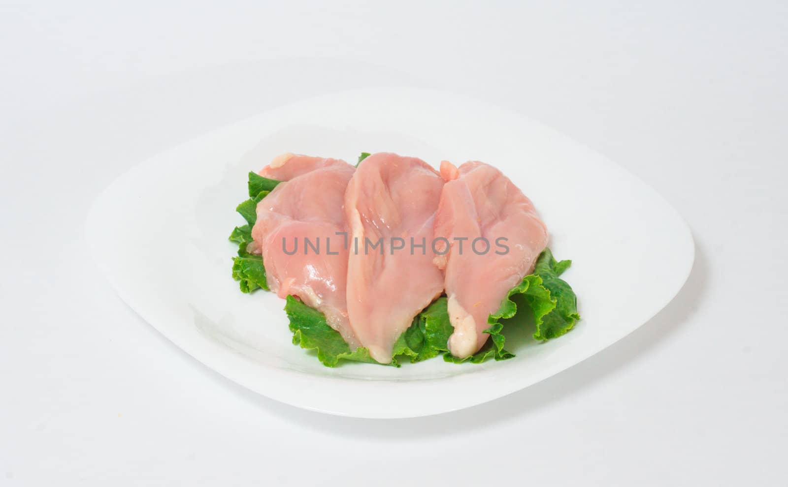 A pair of skinless chicken breasts on a white dish