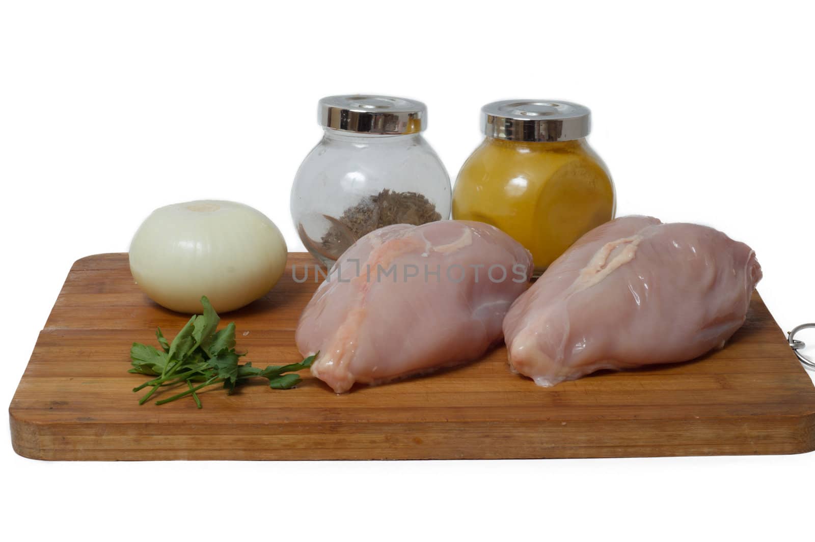 A pair of skinless chicken breasts on a cutting board