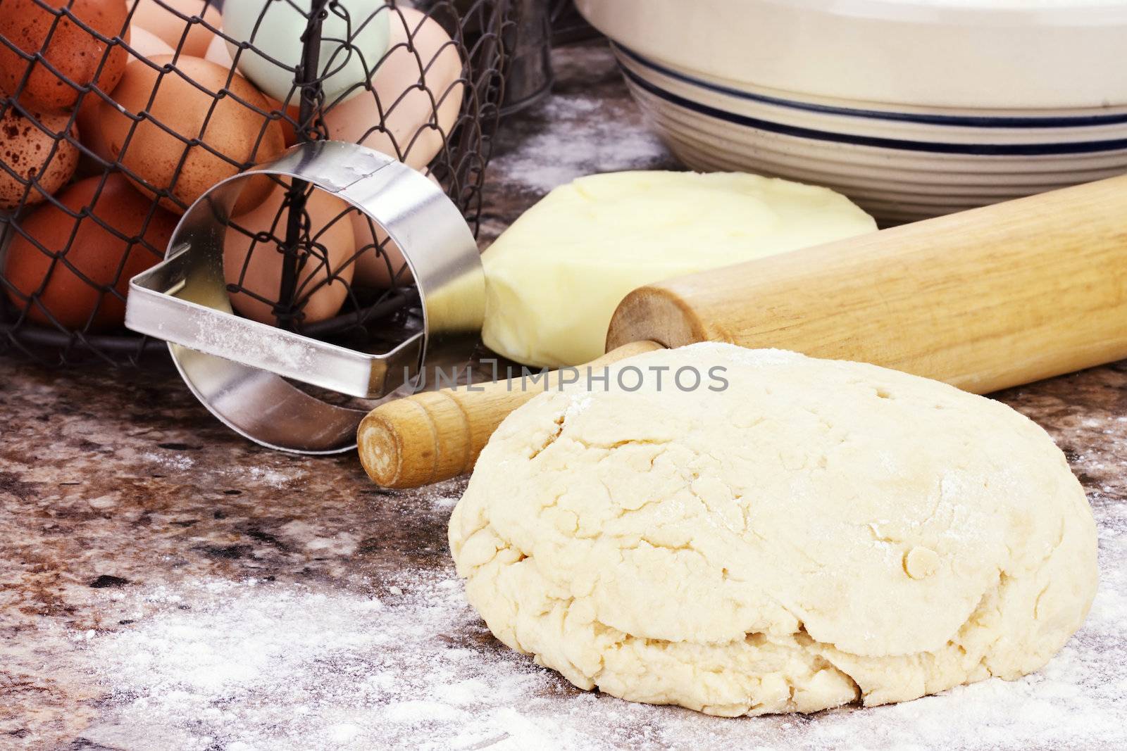 Dough and fresh butter, eggs and flour for making biscuits or bread.  