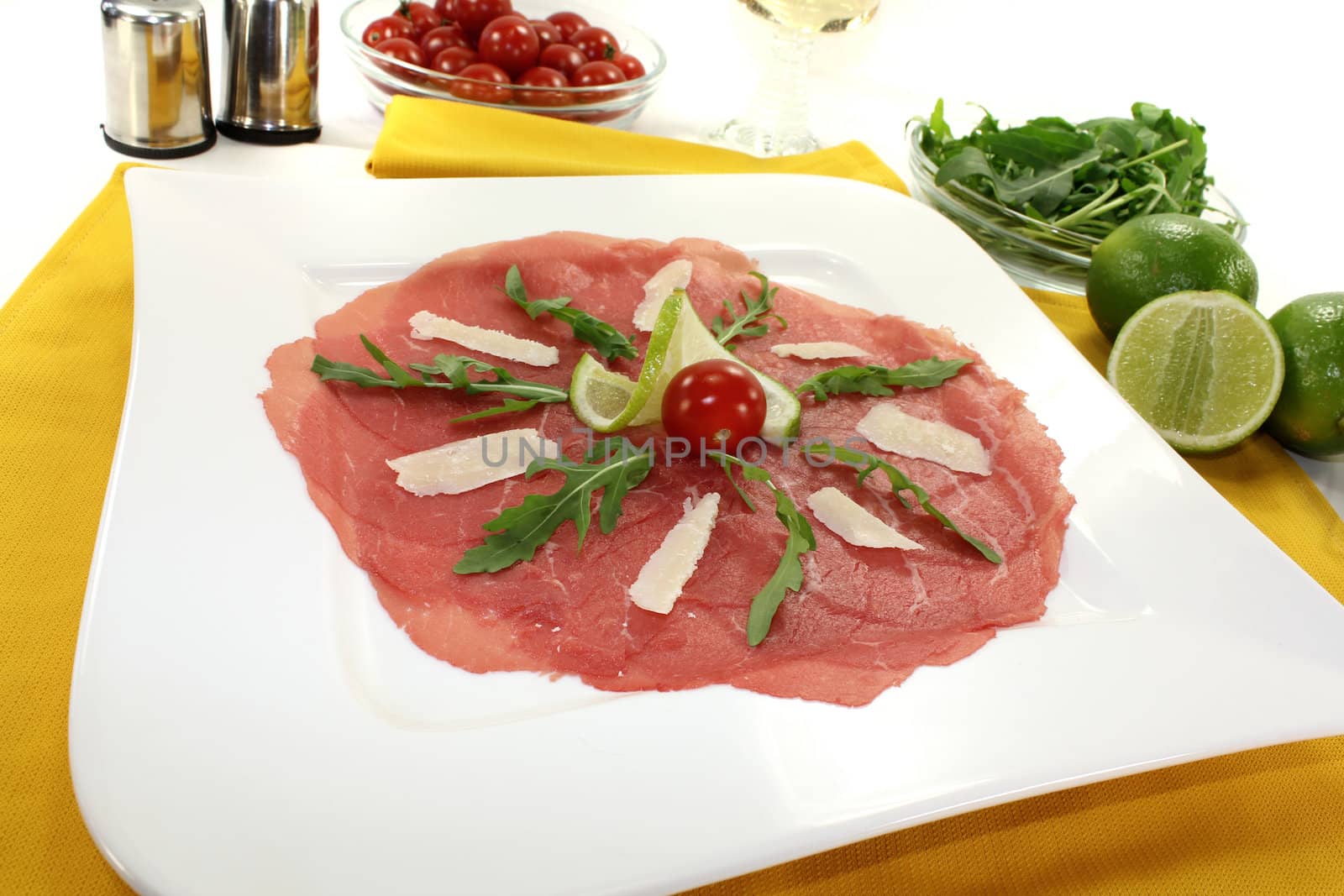 Beef carpaccio with parmesan, rocket, tomatoes and white wine