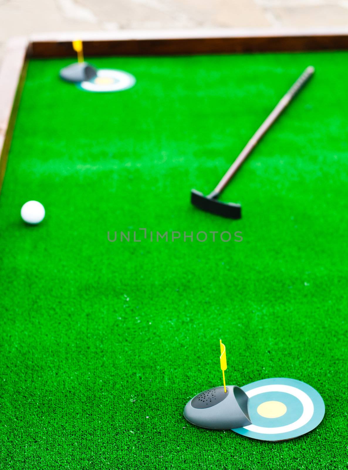 Mini golf field with ball and golf club