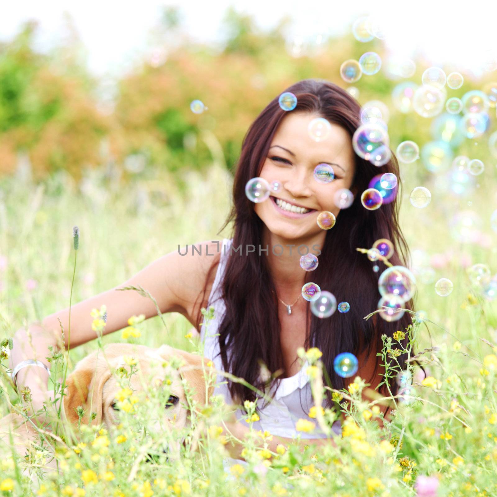 woman and she lablador dog in green grass