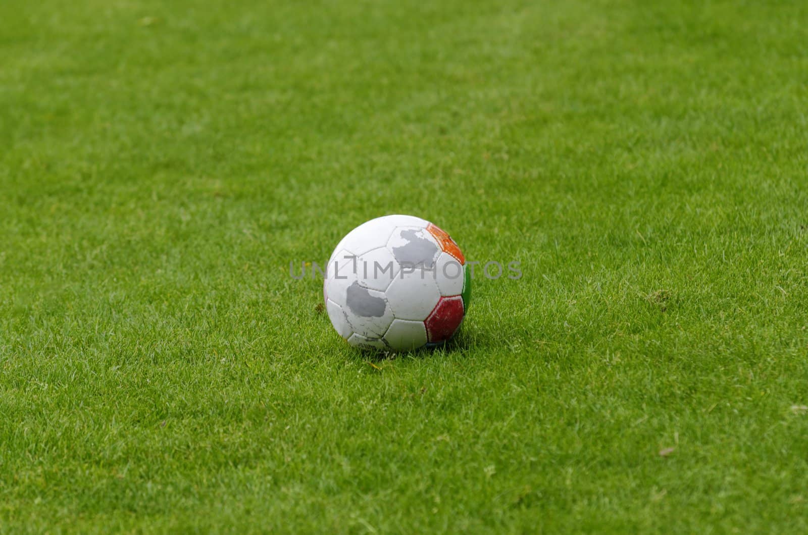 an isolated balloon on a football field