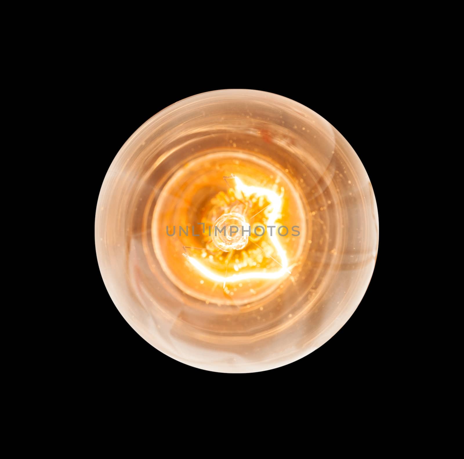 Light bulb illuminated and taken from above and isolated against black