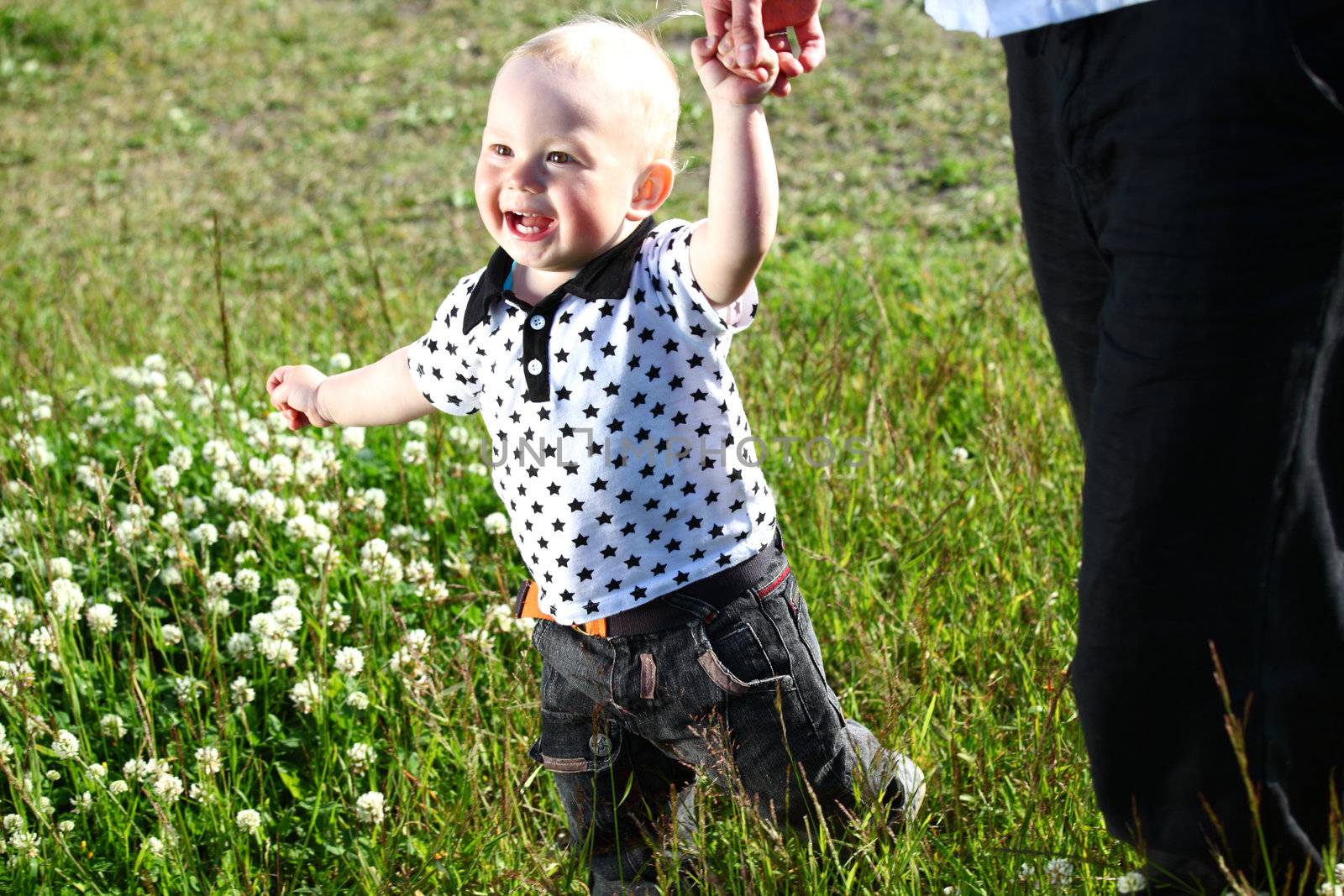 father and son walking on grass