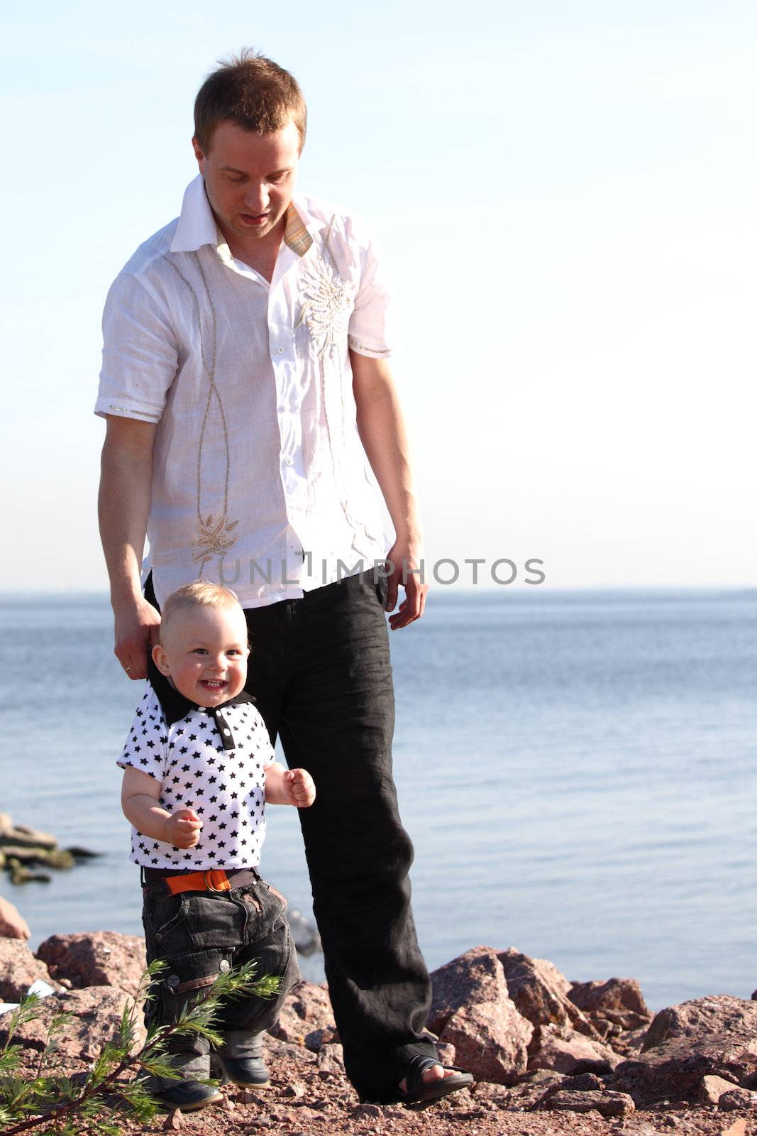 father and son walking on grass