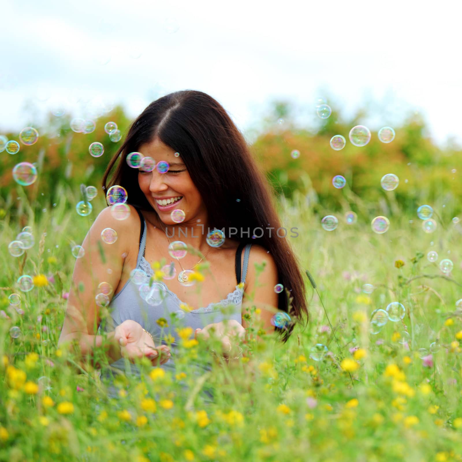 girlfriends on green grass field in soap bubbles