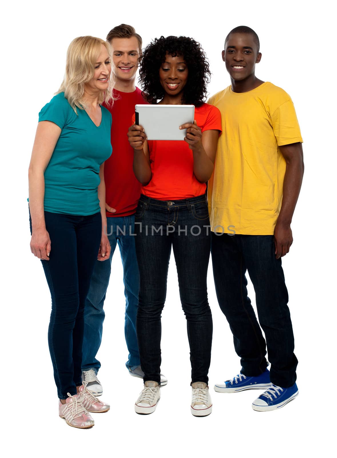 Casual teen group watching video on tablet pc, full length shot